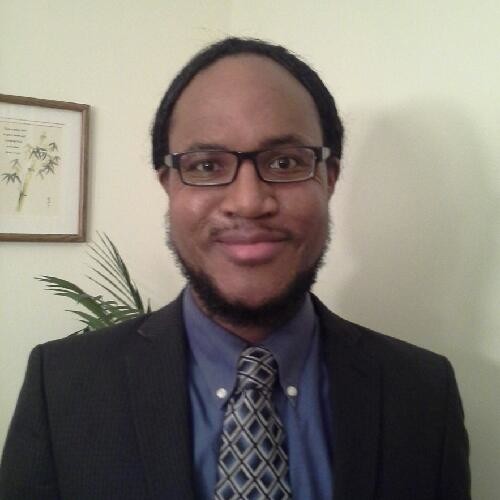 Jason Smith (headshot), director of youth justice policy for Michigan Council on Crime and Delinquency, smiling man in glasses, dark blue shirt, black jacket, patterned tie