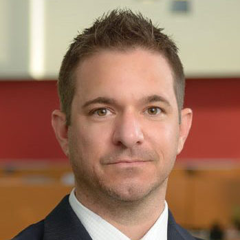 Jeff Kretschmar (headshot), managing director of Begun Center for Violence Prevention Research and Education, serious-looking guy with short, ruffled hair, dark pinstripe suit, white shirt, blue striped tie