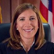Judge Linda Tucci Teodosio (headshot), juvenile court judge for Summit County Juvenile Court in Akron, Ohio, smiling woman with earrings, shoulder-length brown hair, judicial robe