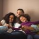 family social and economic mobility grants; young, happy African-American family on couch