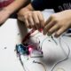 science education outreach grants; children working on circuit and laser project