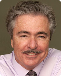 California: Smiling man with gray hair, mustache, pink shirt