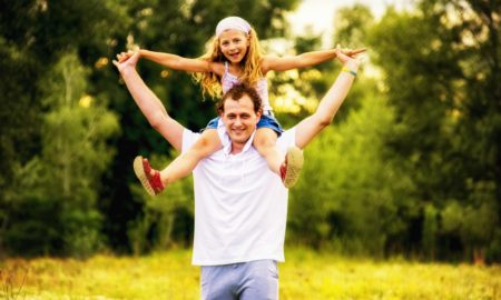 human services, environment, etc grants; daughter on father's shoulders in park