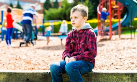 improving care for children with add/adhd and tourrete's; child sitting alone at playground