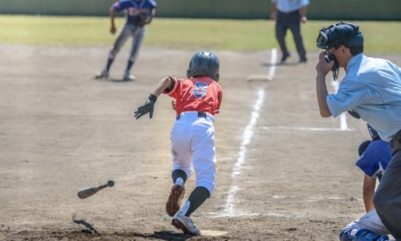 youth baseball/softball grants; youth player runs towards first base after hit