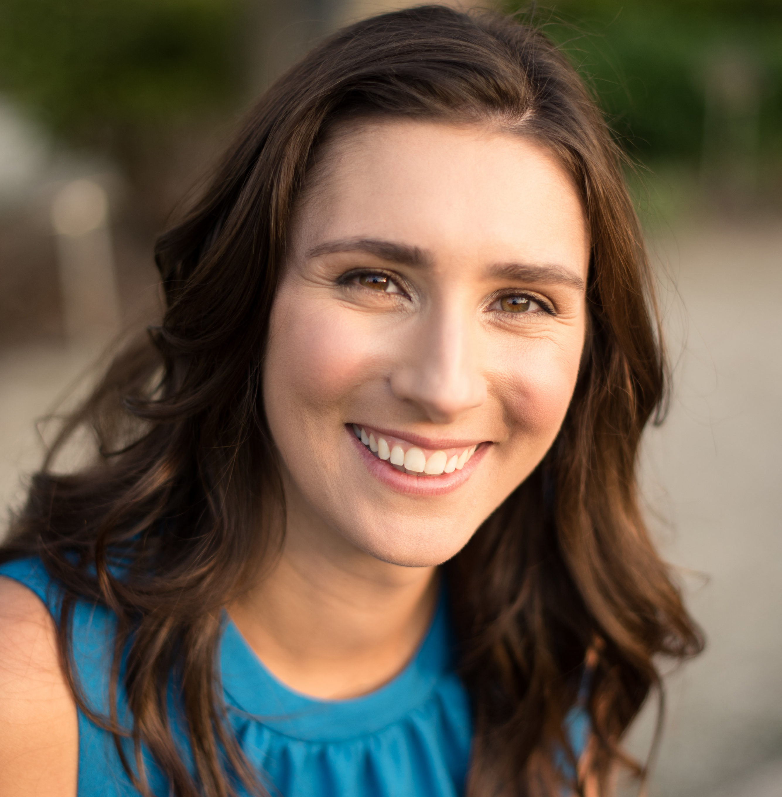sexually exploited: Jenna Kreuzer (headshot), associate director for Wraparound Milwaukee, smiling woman with long brown hair in blue sleeveless top.