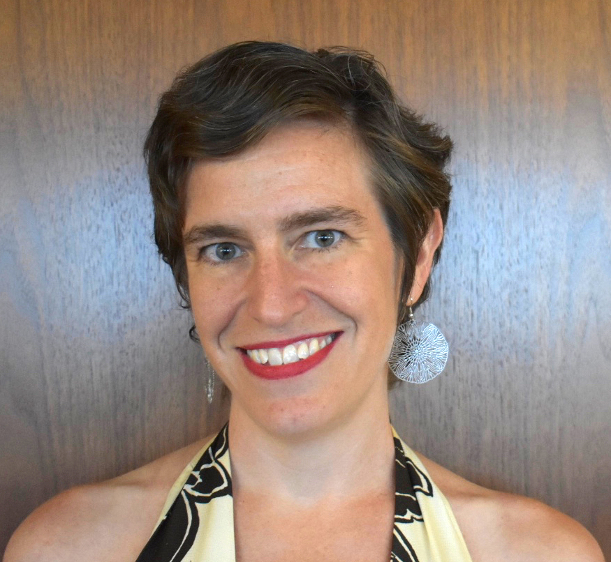 trauma: Shari Silberstein (headshot), executive director of Equal Justice USA, smiling woman with short brown hair, big earrings.