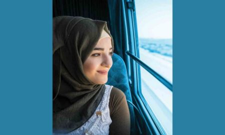 A right to be heard report; young migrant girl in hijab on train