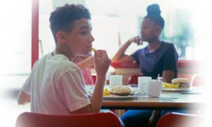food security, healthy food access, hunger alleviation: youth eating at table