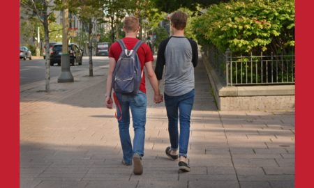 suicidal behavior among sexual minority youth report; gay couple holding hands walking down street