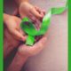 children's mental health grants; adult and children's hands holding green mental health awareness ribbon