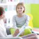 children's mental healthcare access improvement research grants; young girl happy with therapist