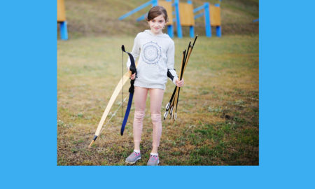 diabetes: Little girl shoots bow with archery