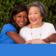 afterschool: Older asian woman mentoring a young African American teenager.