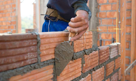 community, safety, workforce dev. grants; worker building brick wall