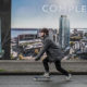 Man skateboards past billboards about new condos.