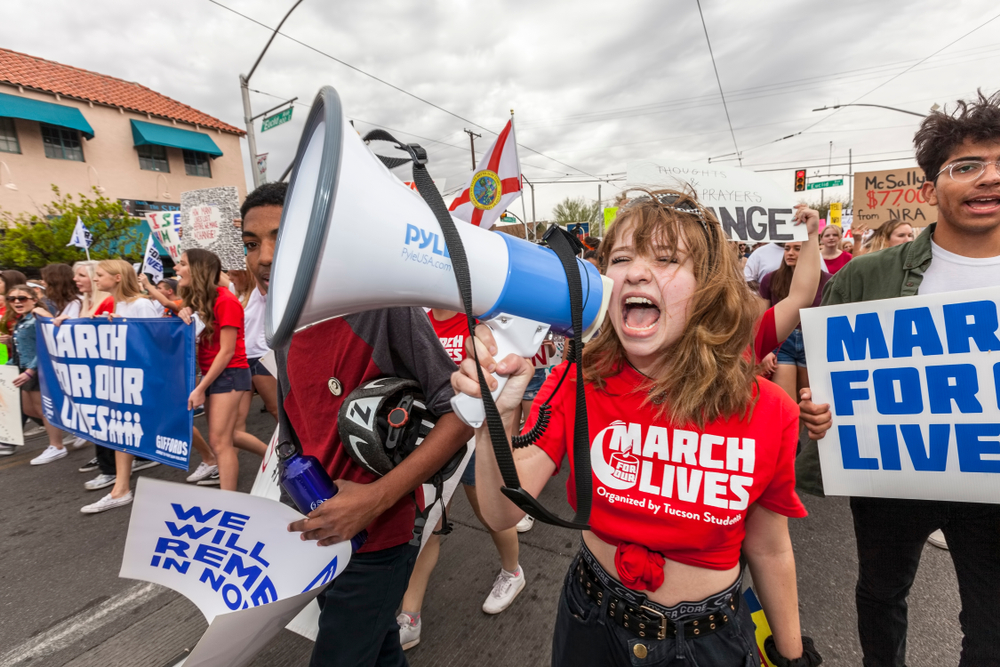youth activists: Unidentified young woman with megaphone at March for Our Lives gun violence protest organized by youth.