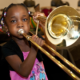 Louisiana afterschool and summer music, arts, culture education grants; young black girl learning trombone