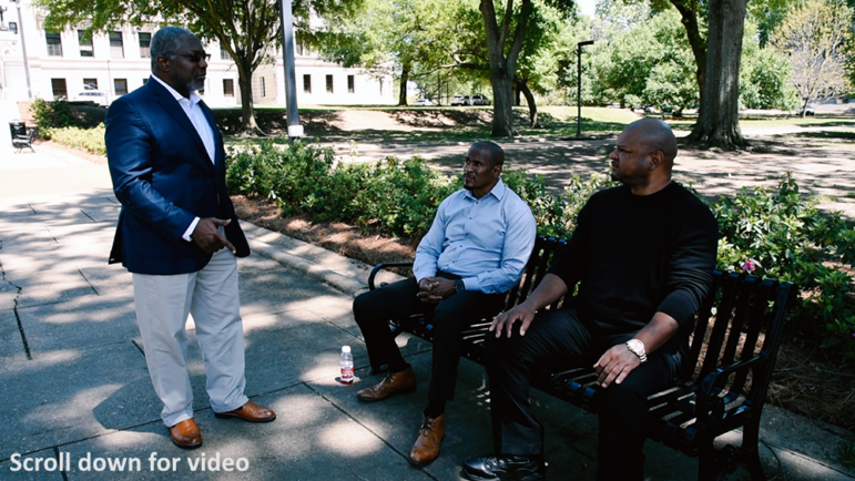 Gun violence trauma: 3 men talk outside in a park