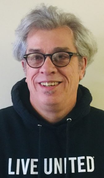 network: T.J. Delahanty (headshot), senior manager at Metro United Way, smiling man with short, thick gray hair, glasses, dark hoodie with Live United on it.