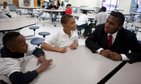 young african american boy learning from mentor
