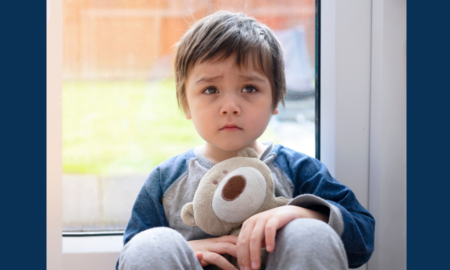 opioid crisis child/youth victims services grants; sad child holding teddy bear in front of window