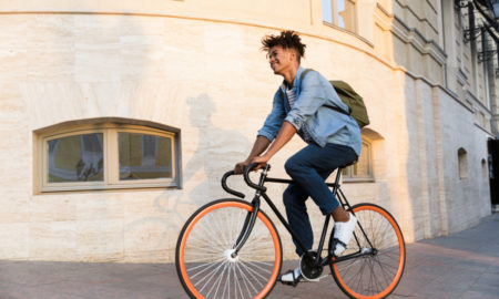 transitions: Cheerful young guy riding bicycle