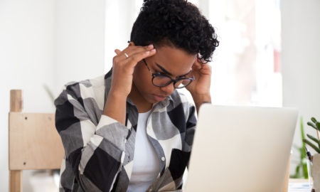 ACEs: Stressed focused african american woman concentrating doing difficult online computer work, frustrated black female student looking at laptop feeling headache tired of study learning overwork