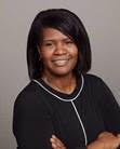 ACEs: Renada Greer (headshot), works with college students from disadvantaged backgrounds at Southern Illinois University Carbondale, smiling woman with shoulder-length dark hair, black outfit.