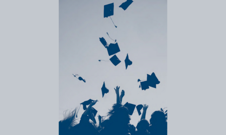 condition of education report cover; graduates throwing caps in the air