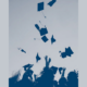 condition of education report cover; graduates throwing caps in the air