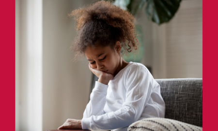 toxic stress and children's outcomes report; troubled african american girl sad on couch