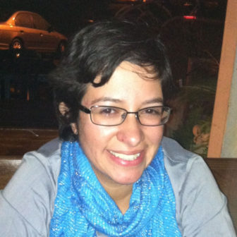 tuition waivers: Liliana Hernandez (headshot), child welfare program specialist in Children's Bureau, smiling woman with short brown hair, glasses, wearing blue patterned scarf, gray blouse.