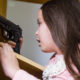 gun safety: Young child finds pistol in cupboard, gun control concept