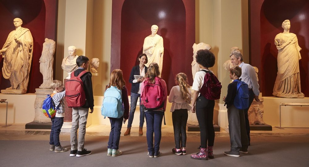 museum support and improvement, humanities education: young students and teacher at history museum