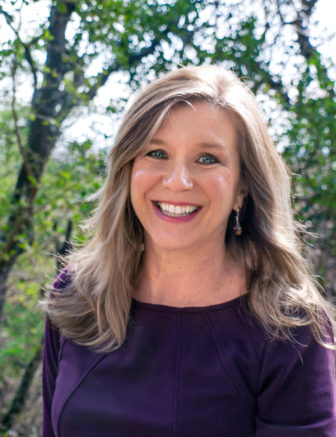  tag: Toni Watt (headshot), professor of sociology at Texas State University, smiling woman with long blond hair, earrings, purple top.