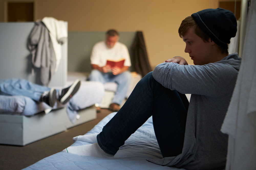 LGBTQ : Youth Lying On Beds In Homeless Shelter