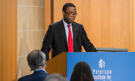 Adewale Adeyemo newsmaker; young african american man in glasses giving speech at podium