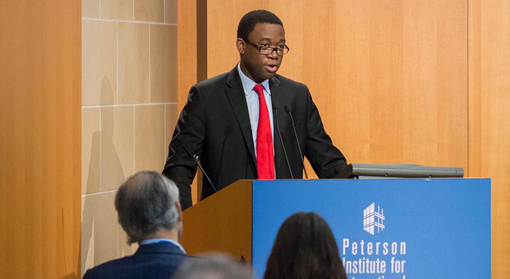 Adewale Adeyemo newsmaker; young african american man in glasses giving speech at podium