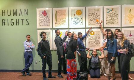 Global Kids: 10 young people pose before framed posters