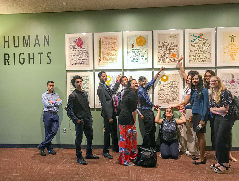 Global Kids: 10 young people pose before framed posters