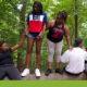 foster care: Kids of color sit and stand on log.
