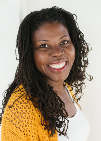 equity: Femi Vance (headshot), researcher at American Institutes for Research, smiling woman with long brown hair, white top, orange sweater.