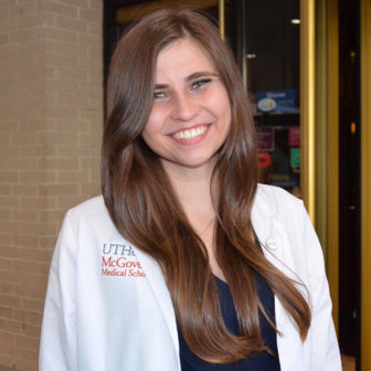 gun violence: Natasha Topolski (headshot), co-course coordinator of Gun Violence and Physicians elective, smiling woman with very long brown hair wearing medical school white coat