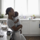 family instability and childrens social development report; happy african american family in kitchen