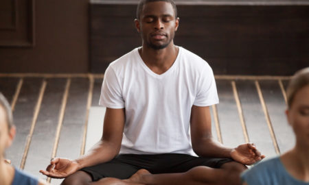 homeless: Young man practicing yoga in class