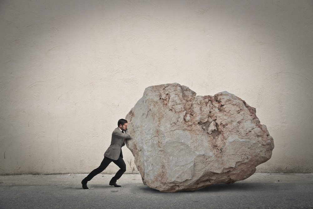 equity: Businessman pushing a boulder