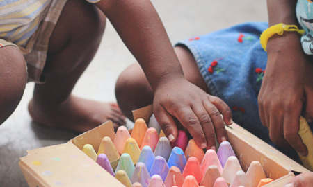 connecticut early care, education and youth development grants; child playing with chalk in daycare