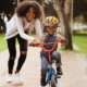 disadvantaged community child welfare program grants; young mother teaching child to ride bike