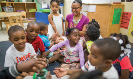 children living in high poverty, low opportunity neighborhoods report; group of black school children in class with teacher